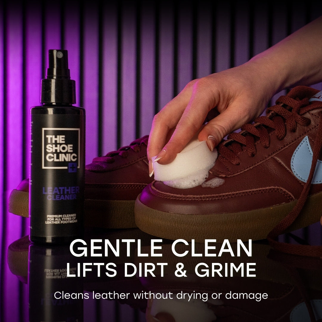 Person cleaning a brown leather shoe with a spray bottle labeled 'The Shoe Clinic, Leather Cleaner' on a purple background.
