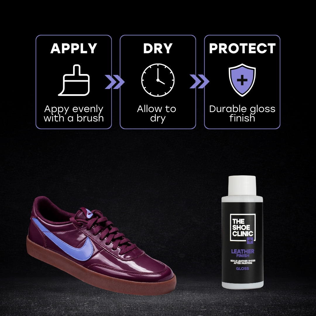 Shiny Maroon sneaker with blue accents and a bottle of leather finish product on a black background