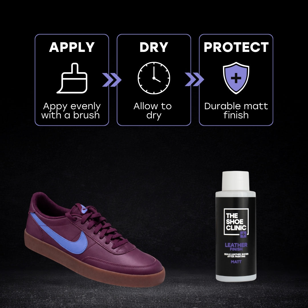 Soft Maroon sneaker with blue accents and a bottle of leather finish product on a black background