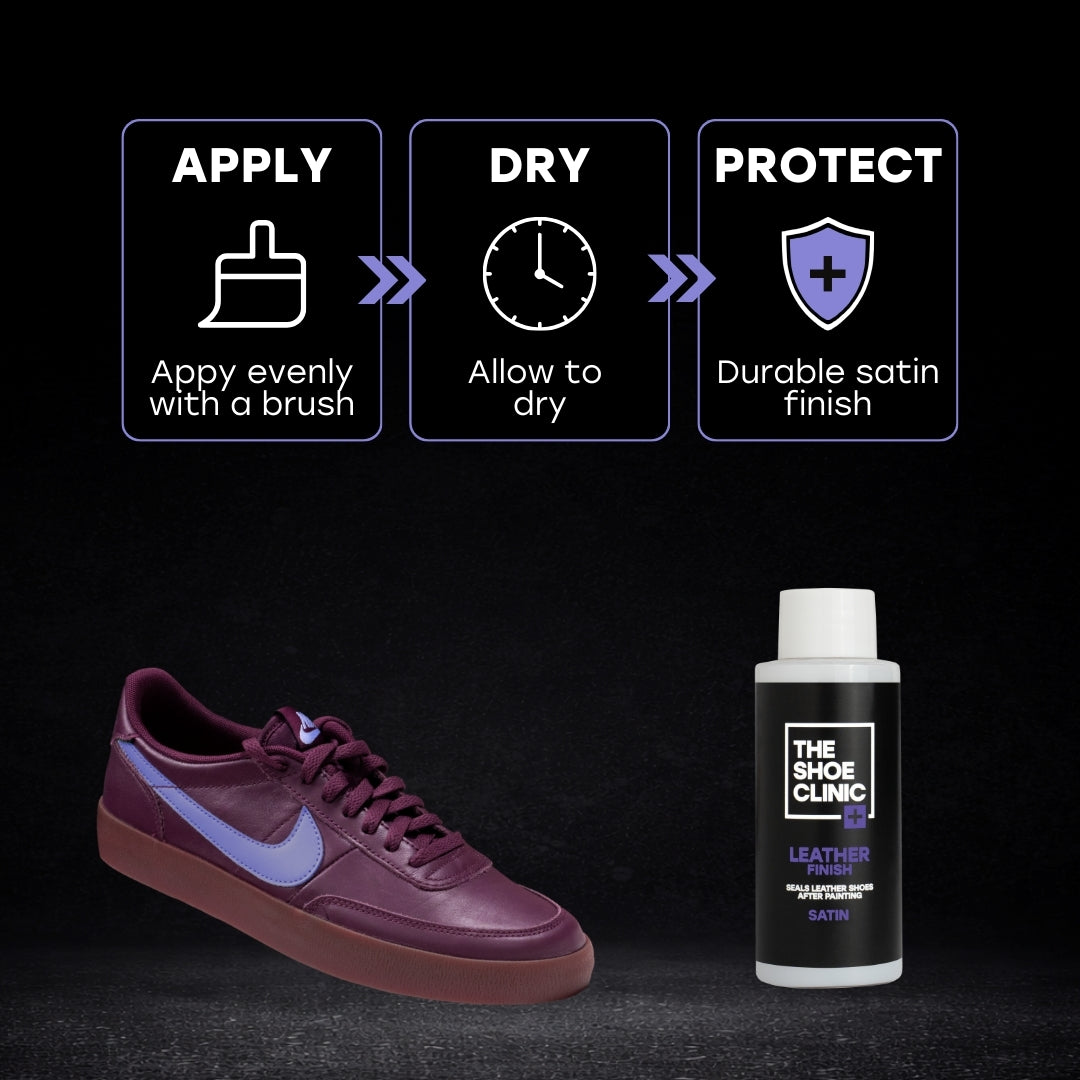 Sleek Maroon sneaker with blue accents and a bottle of leather finish product on a black background