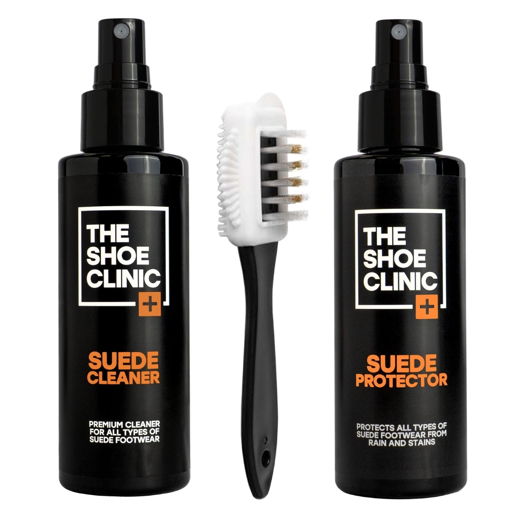 Two black bottles of The Shoe Clinic Suede Cleaner and Suede Protector with a suede brush on a white background.