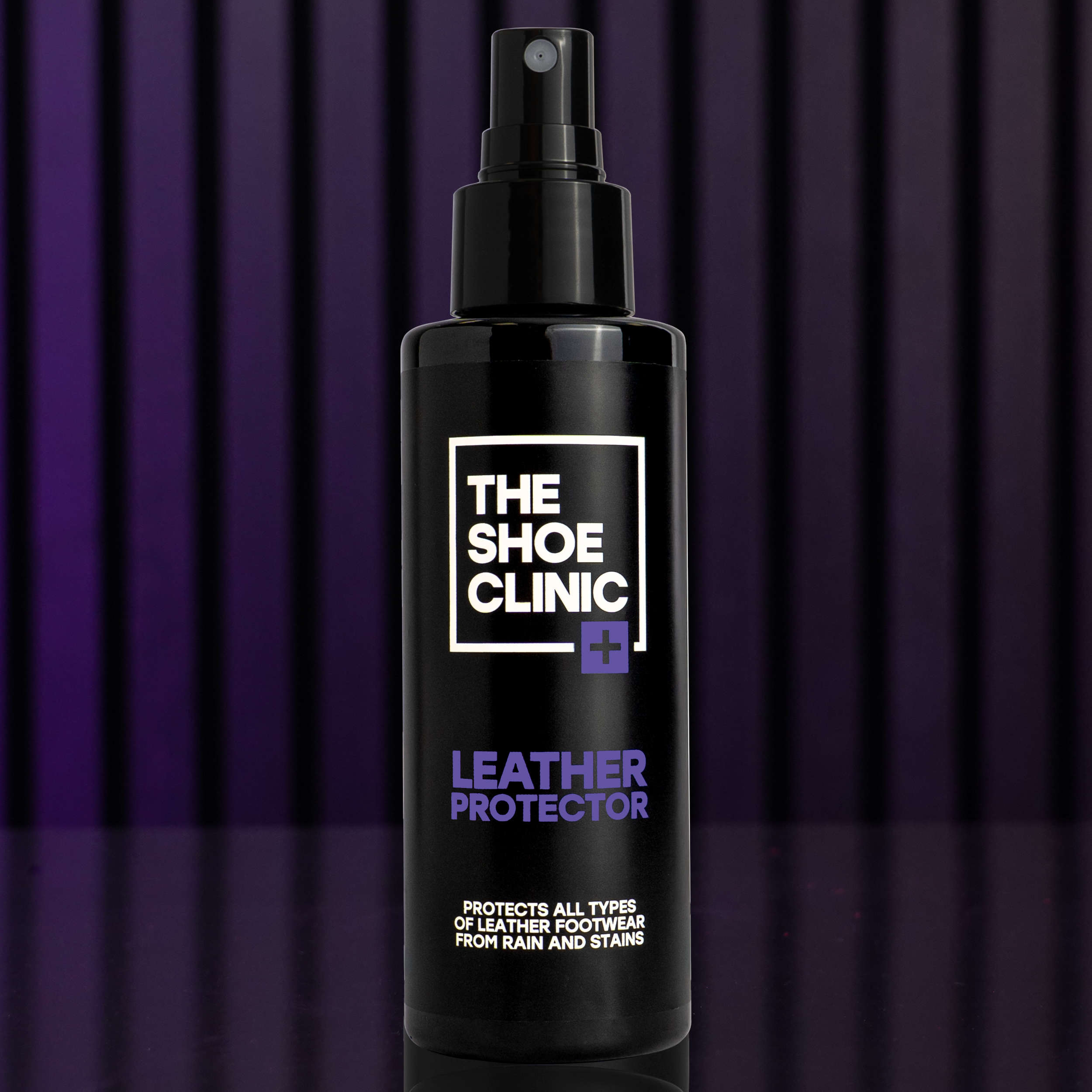 Black bottle of The Shoe Clinic leather protector with a purple background